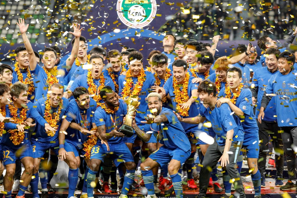 Jiangsu Suning players and staff pose with the 2020 Chinese Super League trophy. Photo: AFP