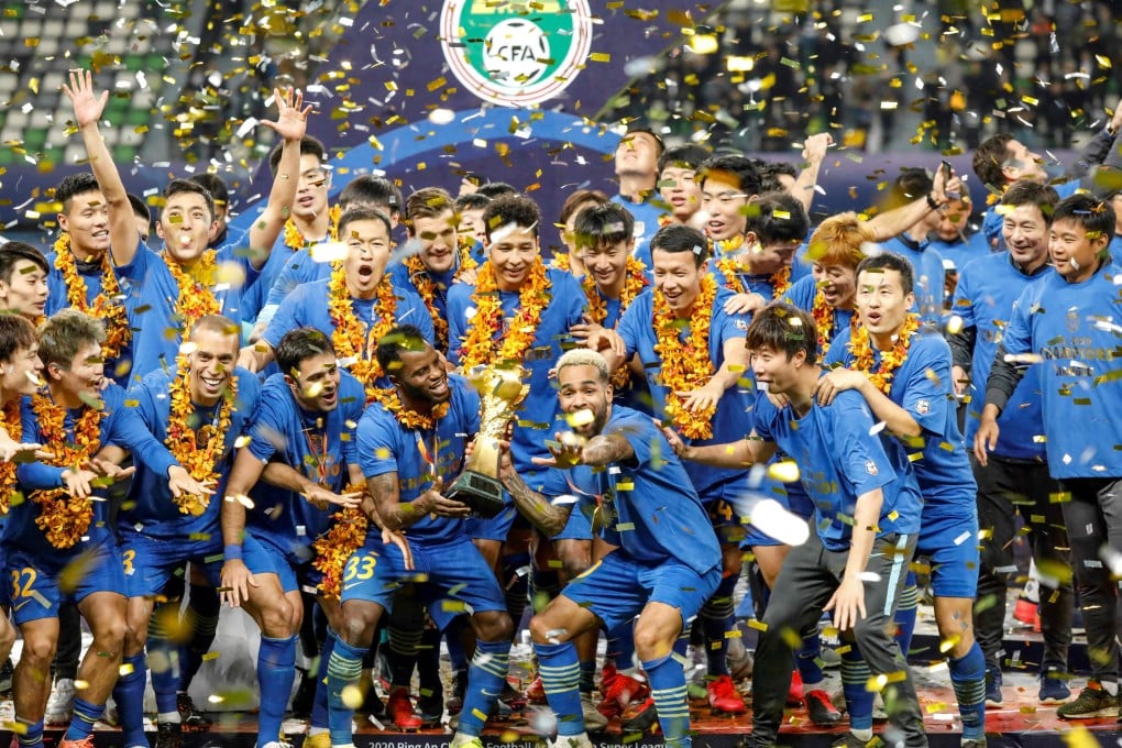 Jiangsu Suning players and staff pose with the 2020 Chinese Super League trophy. Photo: AFP