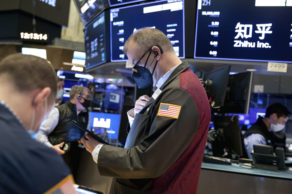 William Lawrence, centre, works with fellow traders on the NYSE floor on Friday. Photo: AP