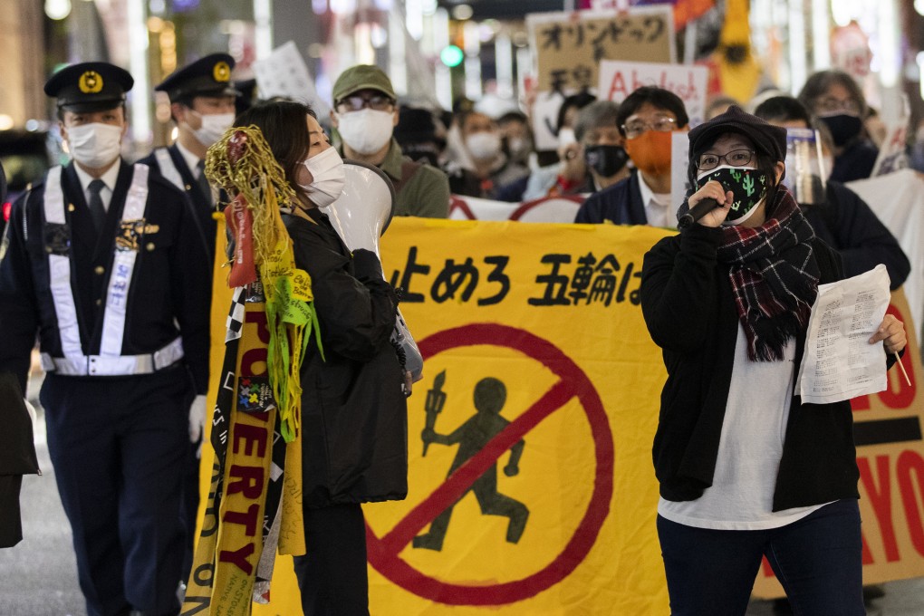 Protesters against the Olympics going ahead march through a Ginza shopping street in Tokyo. Photo: AP