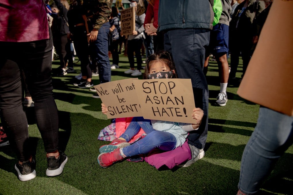 A child holds signs during an AAPI Rally Against Hate in New York on March 21. Photo: Bloomberg
