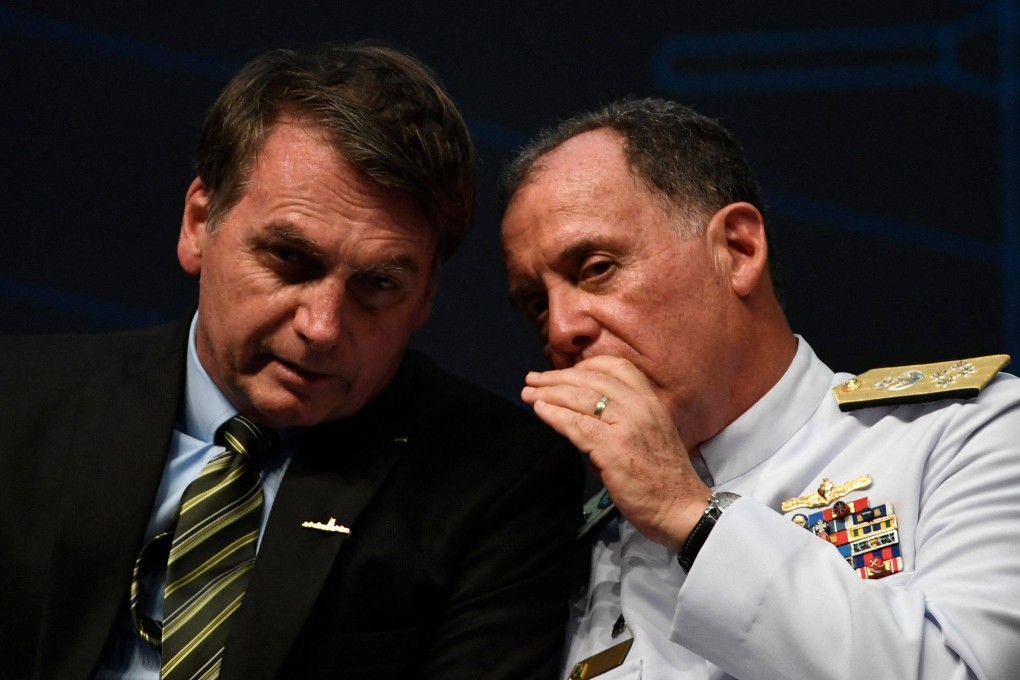 Brazils Navy Commander Ilques Barbosa Junior (right) speaks with Brazilian President Jair Bolsonaro during an event in Rio de Janeiro in October 201. Photo: AFP