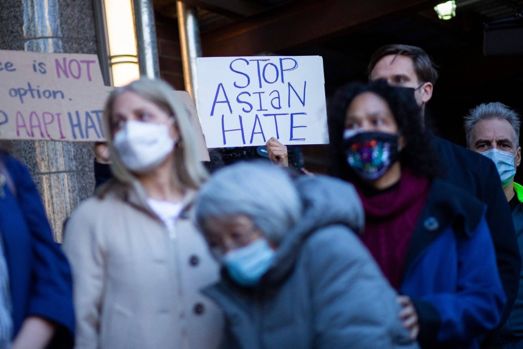 People attend an anti-violence press conference outside the building were a 65-year-old Asian woman was attacked in New York. Photo: AFP