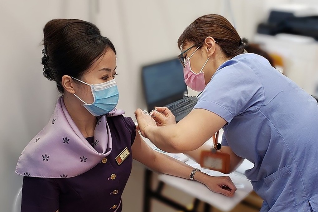 A Hong Kong Airlines employee receives their first dose of a Covid-19 vaccine. Photo: Handout