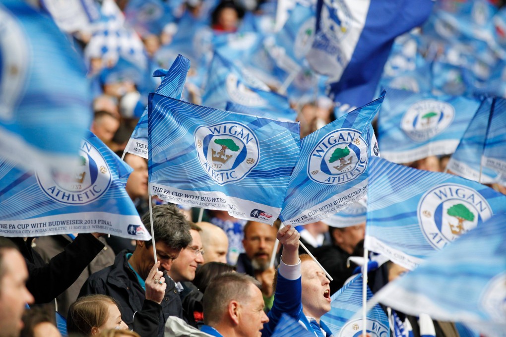 Wigan Athletic fans wave flags before the start of the 2013 English FA Cup final against Manchester City. Photo: AFP