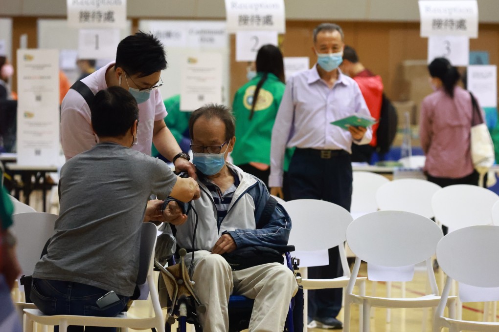 People queue for receive the BioNTech jab at the Hiu Kwong Street Sports Centre in Kwun Tong on 16MAR21. Photo: May Tse