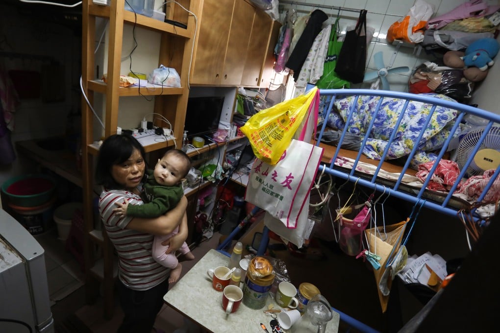 Ho Mei-ying lives with her eight-month-old son Zhang Hoi-shun and two other family members in a 100 sq ft subdivided flat in Cheung Sha Wan. Photo: Jonathan Wong