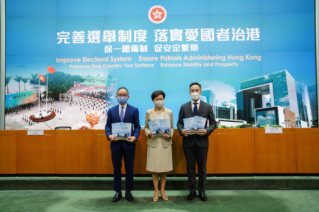 Hong Kong leader Carrie Lam (middle) with Secretary for Constitutional and Mainland Affairs Erick Tsang Kwok-wai (left) and Permanent Secretary for Constitutional and Mainland Affairs Roy Tang Yun-kwong at government headquarters on Tuesday. Photo: Sam Tsang