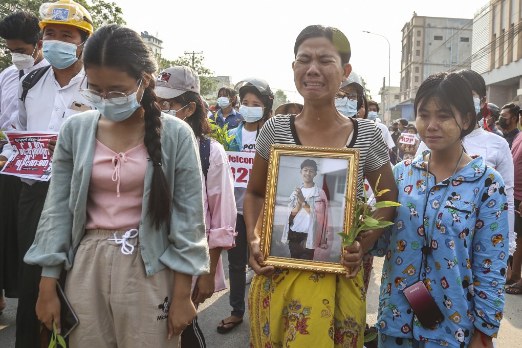 A mother cries as she holds a portrait of her son who died during a protest against the military coup in Myanmar. Photo: EPA-EFE