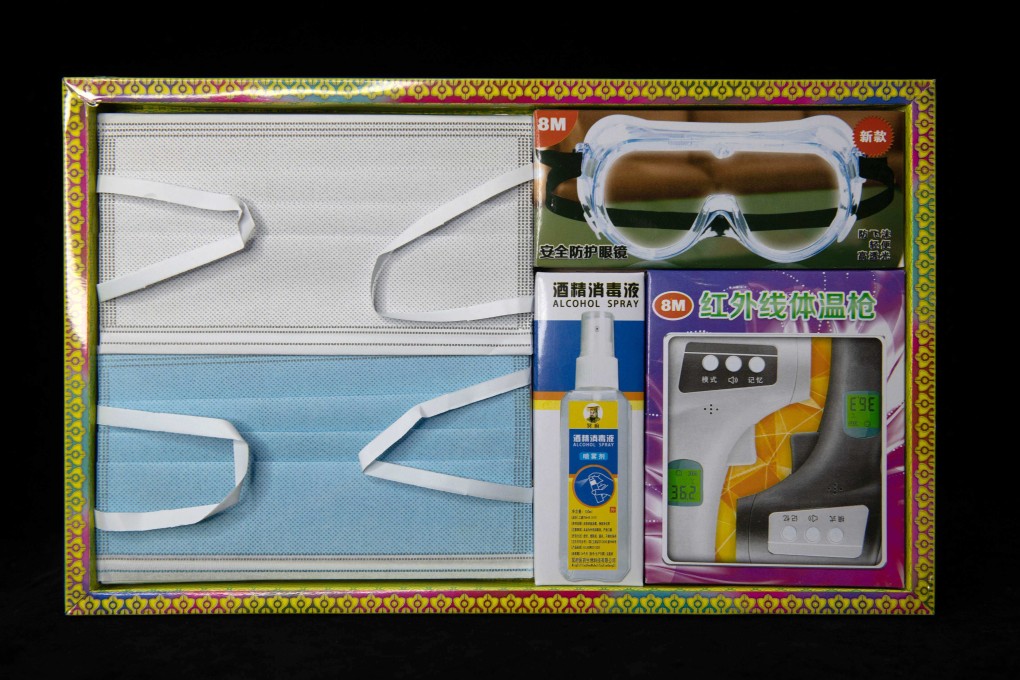 Coronavirus-themed offerings for Malaysia’s tomb sweeping day include face masks, goggles, a bottle of hand sanitiser and a thermometer that ancestors can use to help fight off Covid-19 in the afterlife. Photo: AFP
