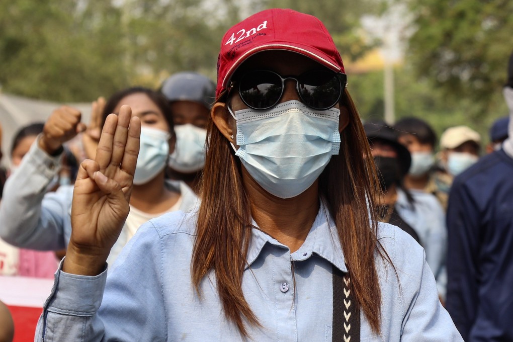 A protester flashes a three-finger salute during a march to condemn the military coup in Mandalay. Photo: EPA-EFE