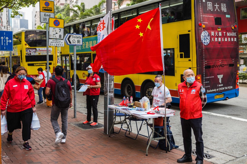 China’s national flag is displayed at a stall where residents can sign in favour of changes to the local electoral system in Hong Kong on March 11. Photo: AFP