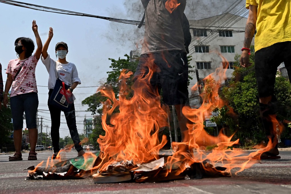 Protesters make the three-finger salute in Yangon. Photo: STR / AFP