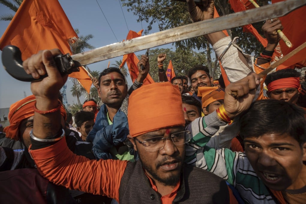 Hindu hardliners, one brandishing a sword, chant slogans against Muslim communities during a rally in 2018 in Uttar Pradesh. Photo: AP