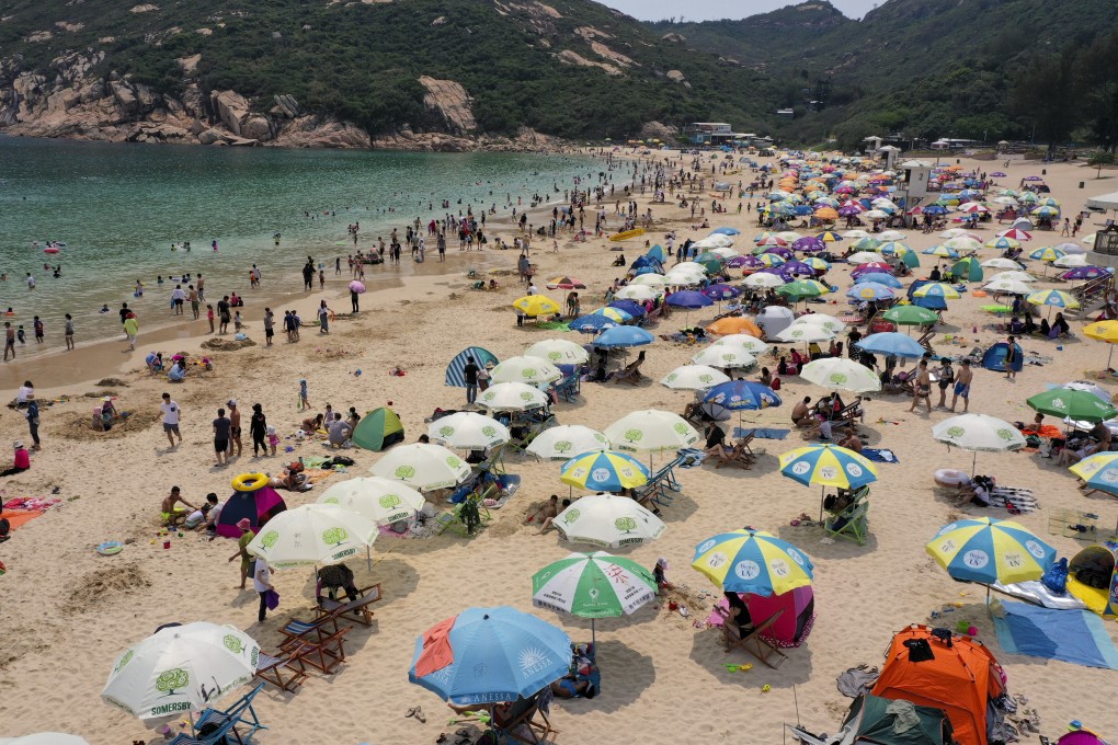 Beachgoers enjoy the sun and sand at Shek O after it reopened on Friday. Photo: Felix Wong