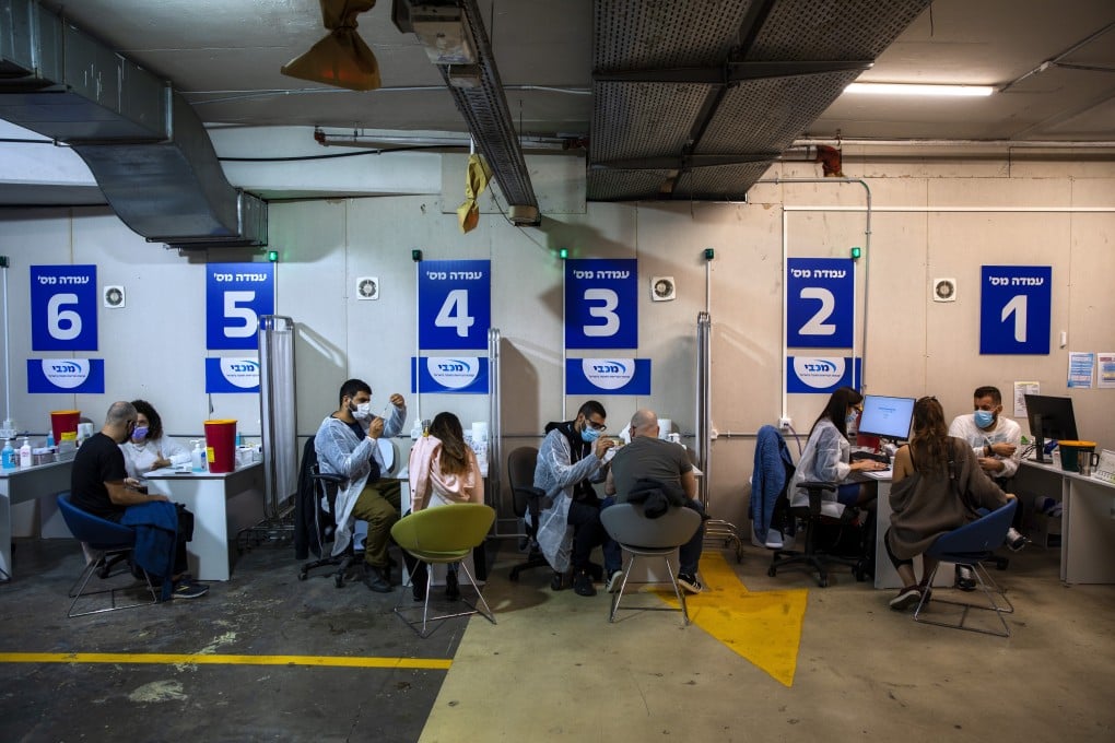 Israelis take the Pfizer-BioNTech vaccine at a vaccination centre in a shopping mall parking lot in Givataim, Israel. Even in Israel, the country with the fastest vaccine roll-out, the drive is slowing. Photo: AP