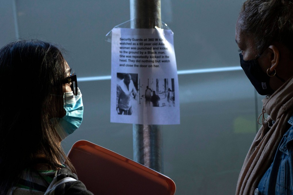 Women look at a poster showing Brandon Elliot, the suspect in Monday’s attack on a 65-year old Filipino woman in New York. Photo: AFP