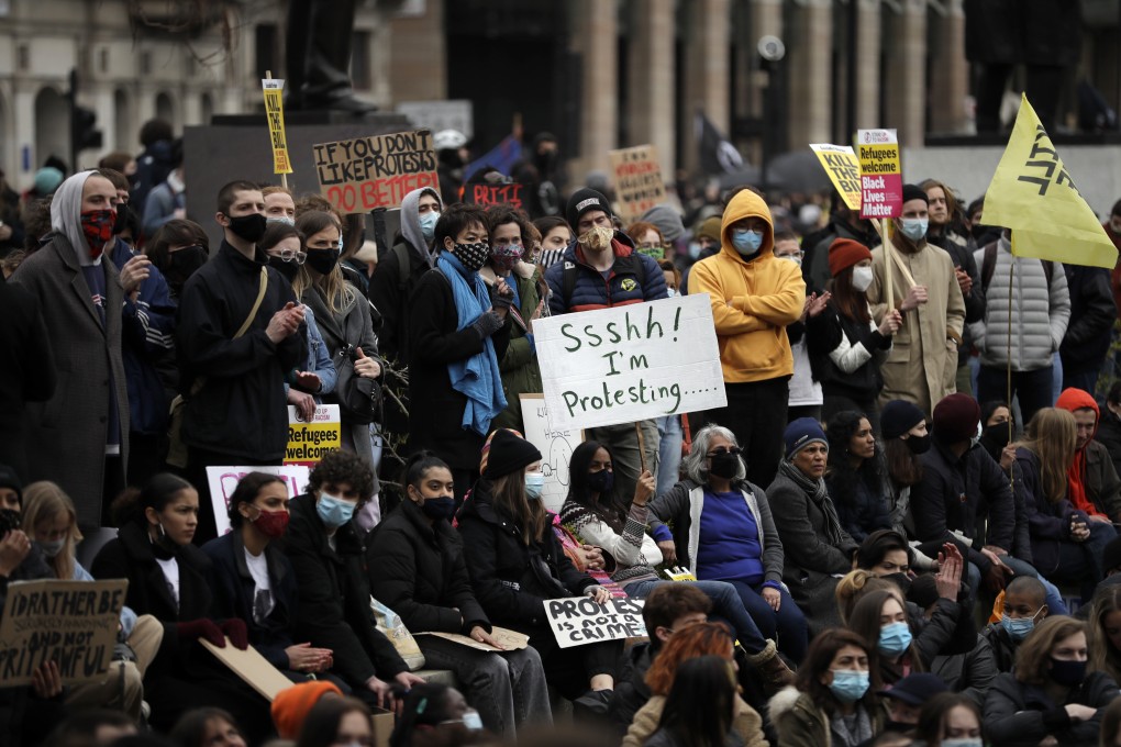 Demonstrators holding posters and flags gather at Parliament Square during a “kill the bill” protest in London. Photo: AP