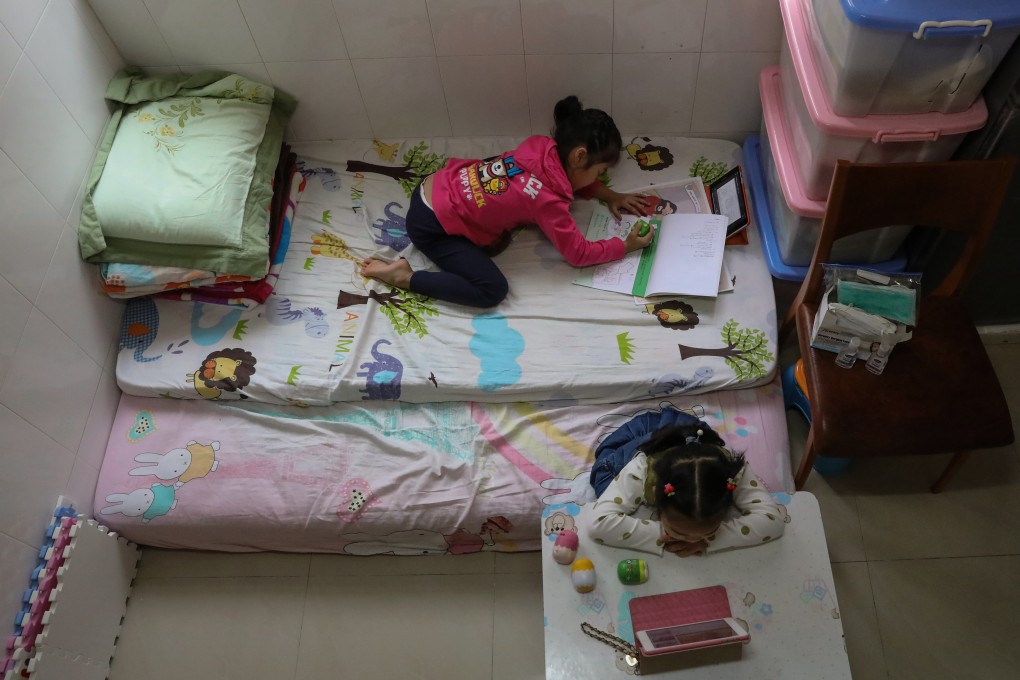 Children doing homework at a subdivided flat in Tsuen Wan. Photo: K. Y. Cheng