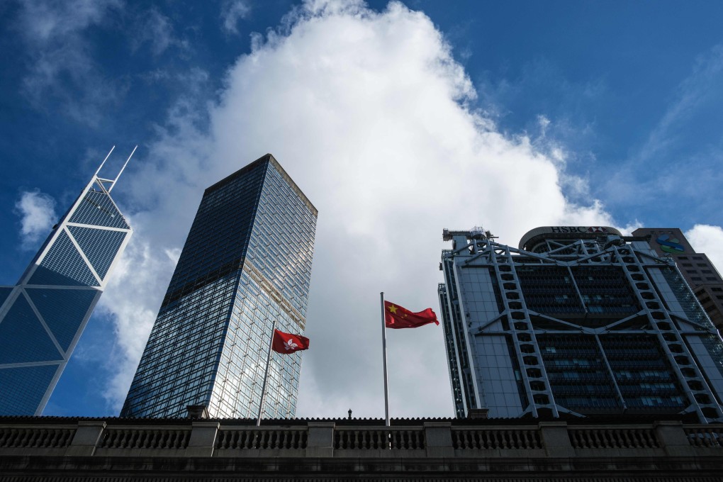 The Chinese national flag and the Hong Kong flag fly in Central. Photo: AFP