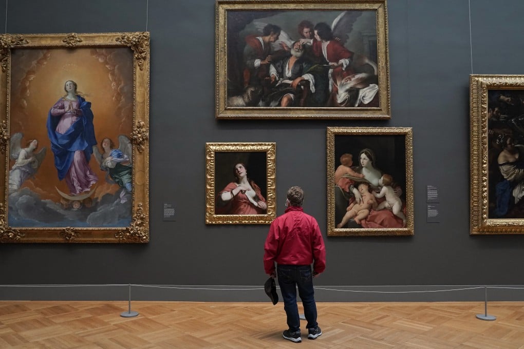 A patron looks at paintings on display at the Metropolitan Museum of Art in New York. Photo: AFP