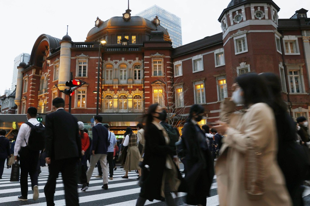 People wearing masks seen in front of the JR Tokyo Station in the Japanese capital. Photo: Kyodo