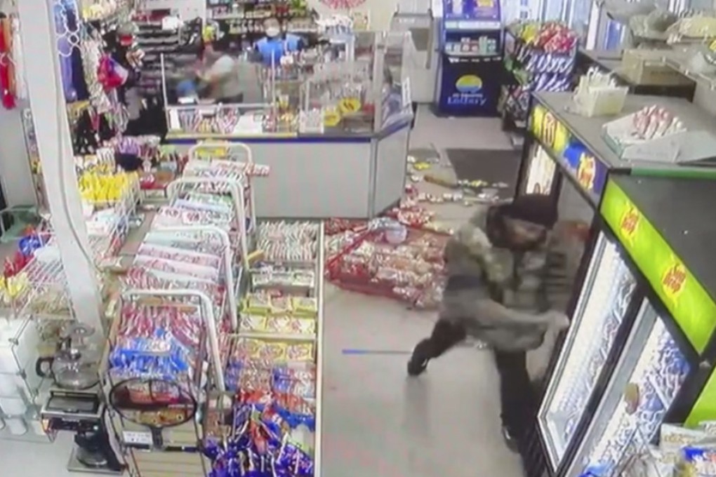 A screengrab from a video shows a man with a pole trashing a convenience store in Charlotte. Photo: Mark Sung/Grace Lee Sung via AP