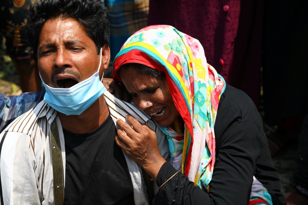 Relatives mourn after several people died as a ferry collided with a cargo vessel and sank on Sunday in the Shitalakshya River in Bangladesh. Photo: Reuters