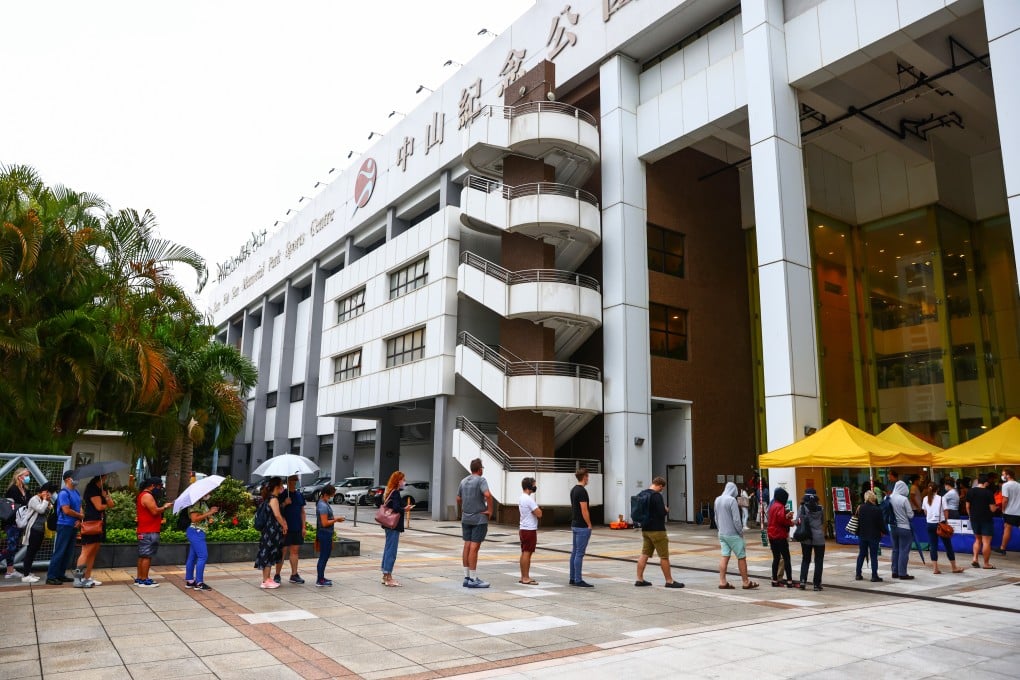 People queue up for BioNTech shots at Sun Yat Sen Memorial Park Sports Centre in Sai Ying Pun, as supply resumed on Monday. Photo: Nora Tam