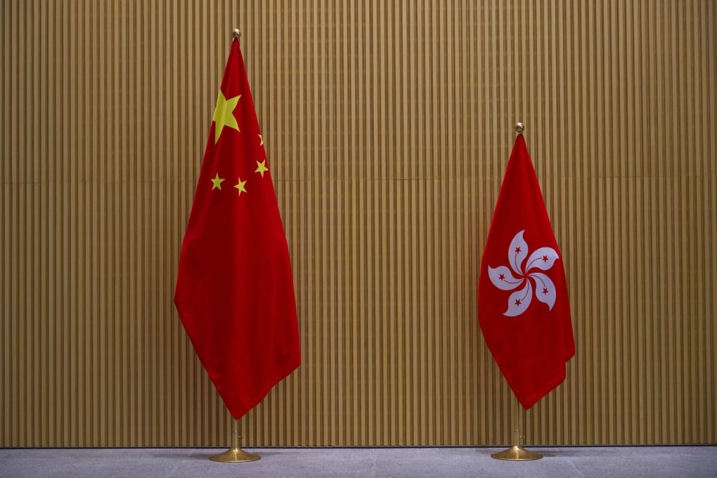 The Chinese national flag and Hong Kong flag are displayed at the central government offices in Hong Kong on March 29. A worldly, internationally connected city of well-informed and highly educated people cannot so easily be turned into a place of slavishly loyal sycophants. Photo: AP