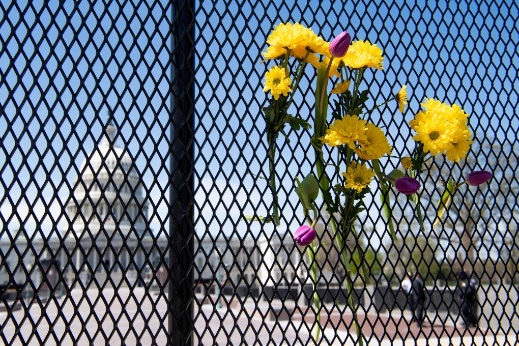 Flowers adorn the fence surrounding the US Capitol in Washington, DC on Saturday. Photo: AFP