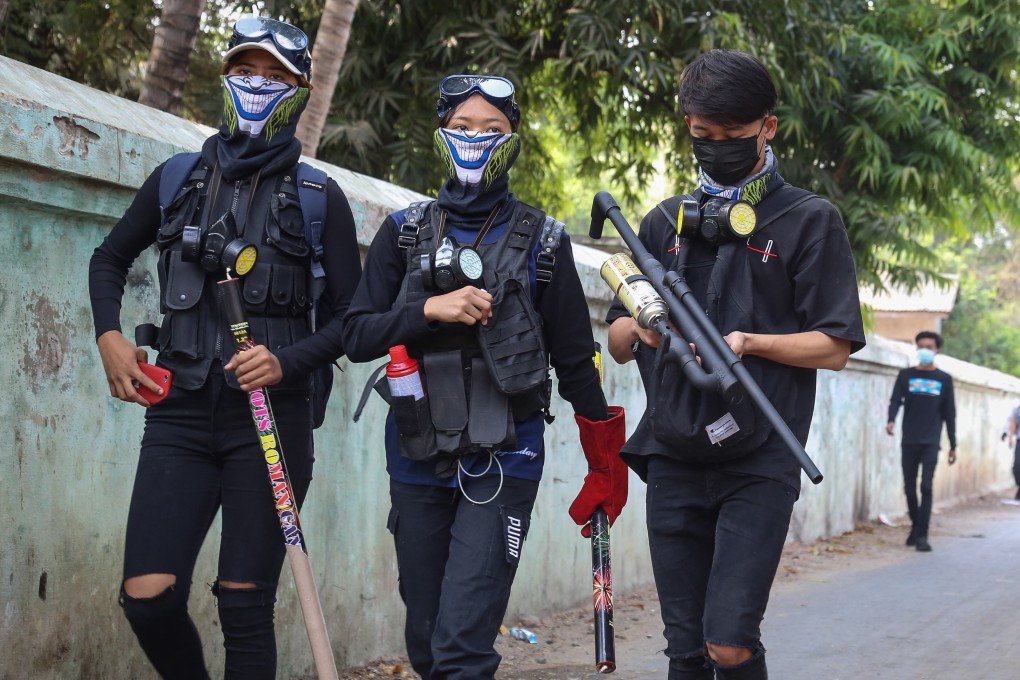 Demonstrators carrying homemade weapons during an anti-military coup protest in Mandalay. Photo: EPA