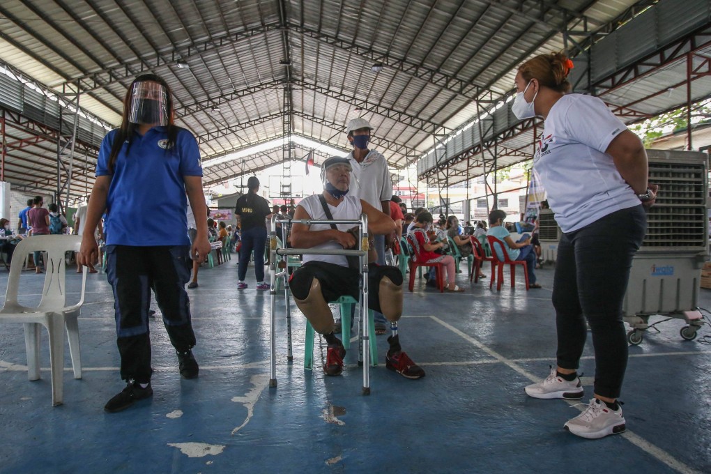 Elderly residents wait to get vaccinated against Covid-19 in Manila on March 30. Photo: AFP