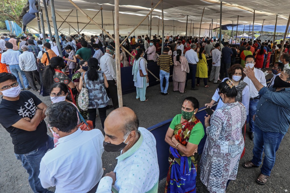 Indians wait in queue to receive Covid-19 inoculation at a vaccination centre in Mumbai city on April 5. The state government of Maharashtra announced new restrictions, including a night curfew and a strict lockdown on the weekends to combat a spike in coronavirus cases. Photo: EPA-EFE