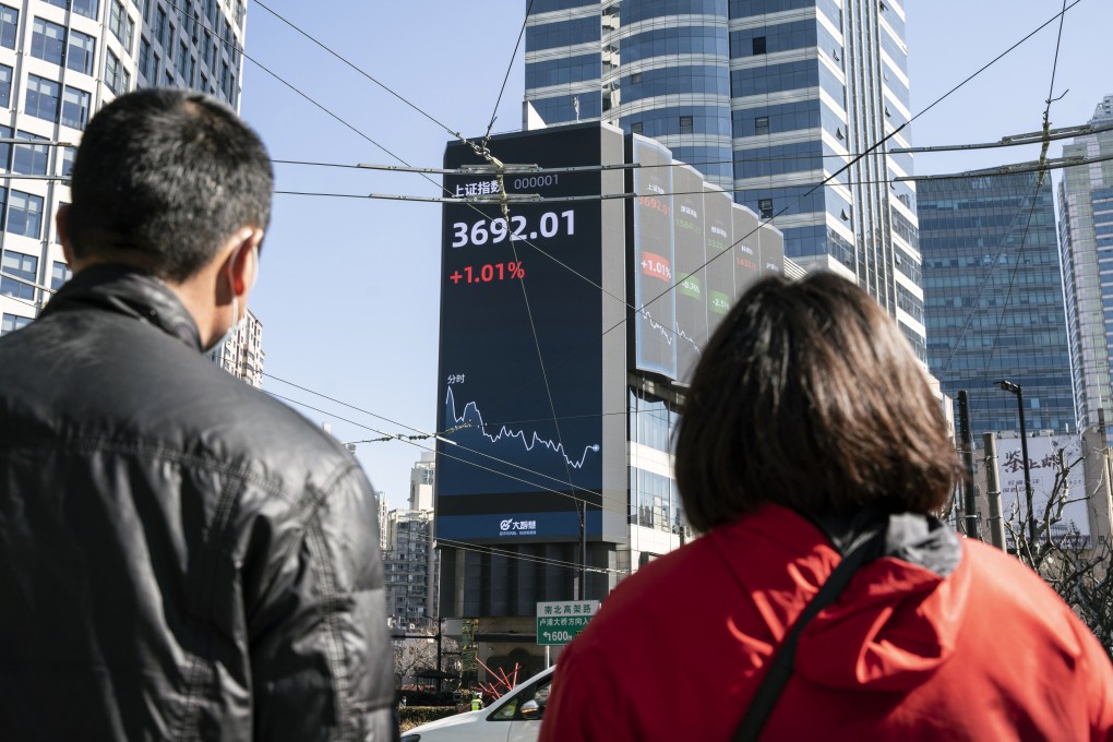 Pedestrians walk past a screen displaying the Shanghai composite index on February 18. China’s stock benchmark erased gains after briefly surpassing its 2007 closing peak, as mainland financial markets opened for the first time following the Lunar New Year break. Photo: Bloomberg