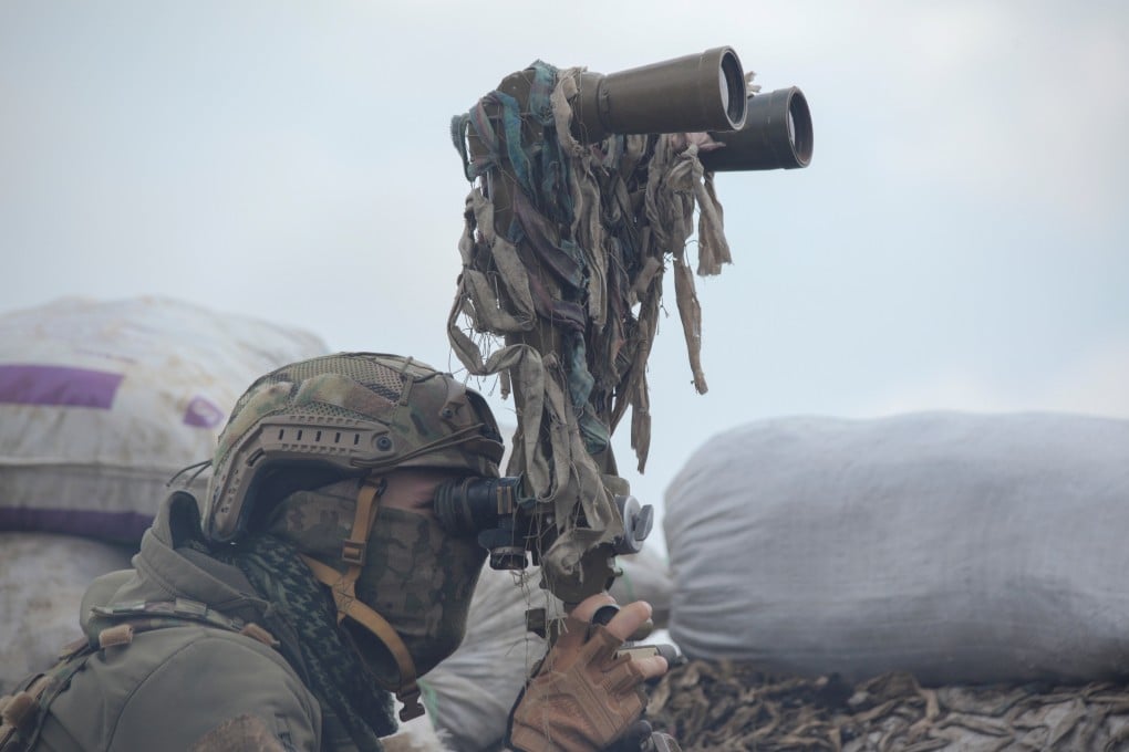 A service member of the Ukrainian armed forces observes positions on the line of separation near the rebel-controlled city of Donetsk, Ukraine. Photo: Reuters