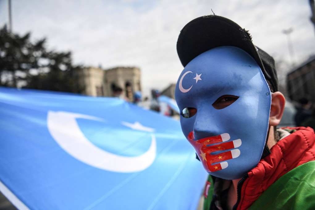 A demonstrator wears a mask painted with the colours of the flag of East Turkestan during a protest by supporters of the Uyghur minority in Istanbul on April 1. Photo: AFP