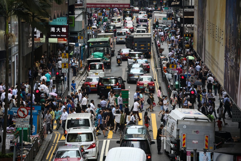 Vehicles and pedestrians jostle for space in Central. Photo: Jonathan Wong