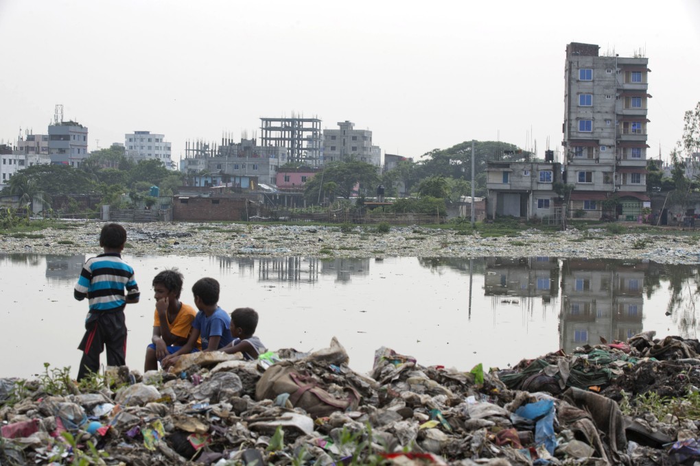 Bangladeshi children sit on garbage piled up by the river Buriganga in Dhaka. Methane from landfill sites and other sources in Bangladesh is drawing the attention of scientists, as the country’s low elevation and high population density make it vulnerable to extreme weather events and rising oceans. Photo: AP