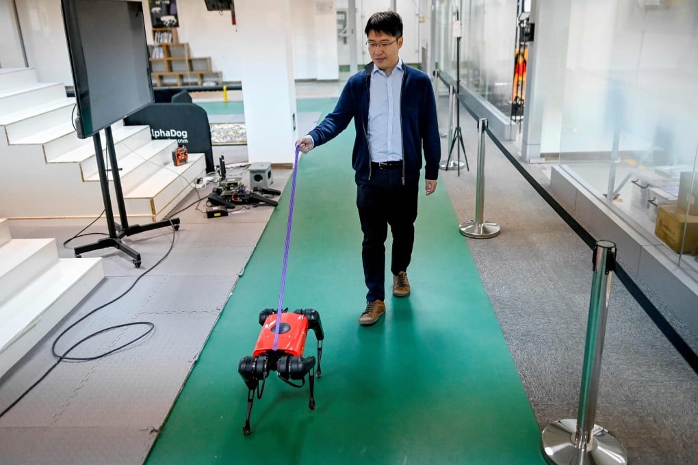 Ma Jie, chief technology officer for Weilan, walks an AlphaDog at the company workshop in Nanjing. Photo: AFP