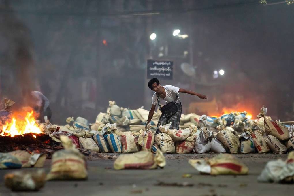 A protester stacks bags on a street as a barricade in Myanmar. China has declined to condemn the coup, which has prompted large-scale demonstrations. Photo: ZUMA Wire