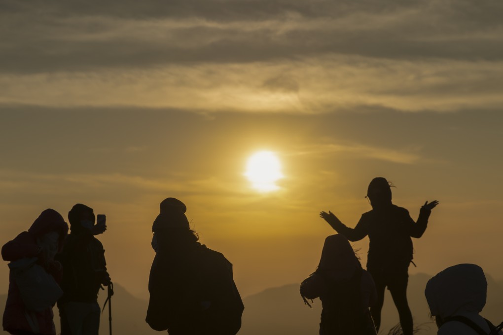 People flock to Tai Mo Shan in cool weather to view the first sunrise of the new year. Photo: SCMP/Winson Wong