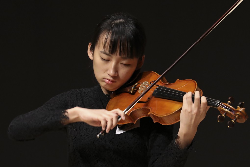 Ding Yi-jie plays the violin at the No Limits press conference. Photo: Roy Issa