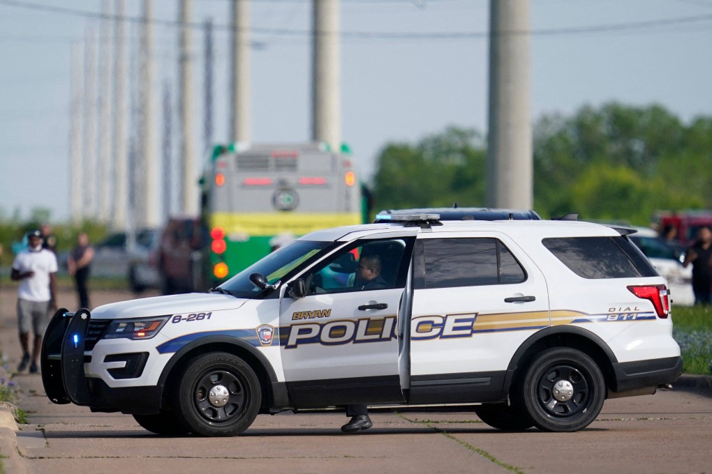 A police officer blocks road access near the scene of a mass shooting at an industrial park in Bryan, Texas, on Thursday. Photo: AFP