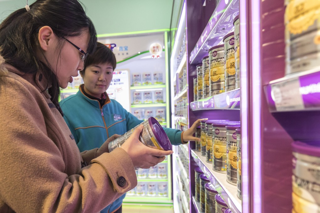 A woman shops for baby milk formula at a store in Shanghai. Photo: Bloomberg