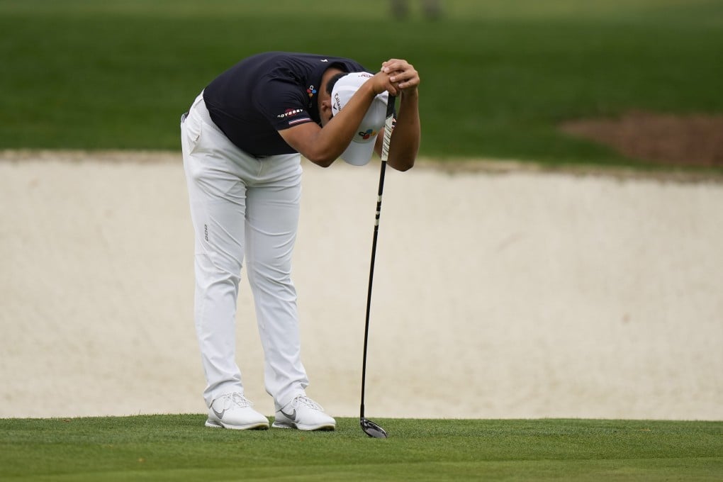 Si Woo Kim, of South Korea, leans on his 3 wood which he had to use to putt on the 16th green during the second round of the 2021 Masters. Photo: AP