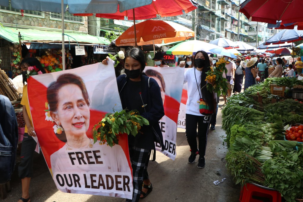Anti-coup protesters hold up posters of ousted Myanmar leader Aung San Suu Kyi, who was hit with fresh criminal charges on Monday. Photo: AP