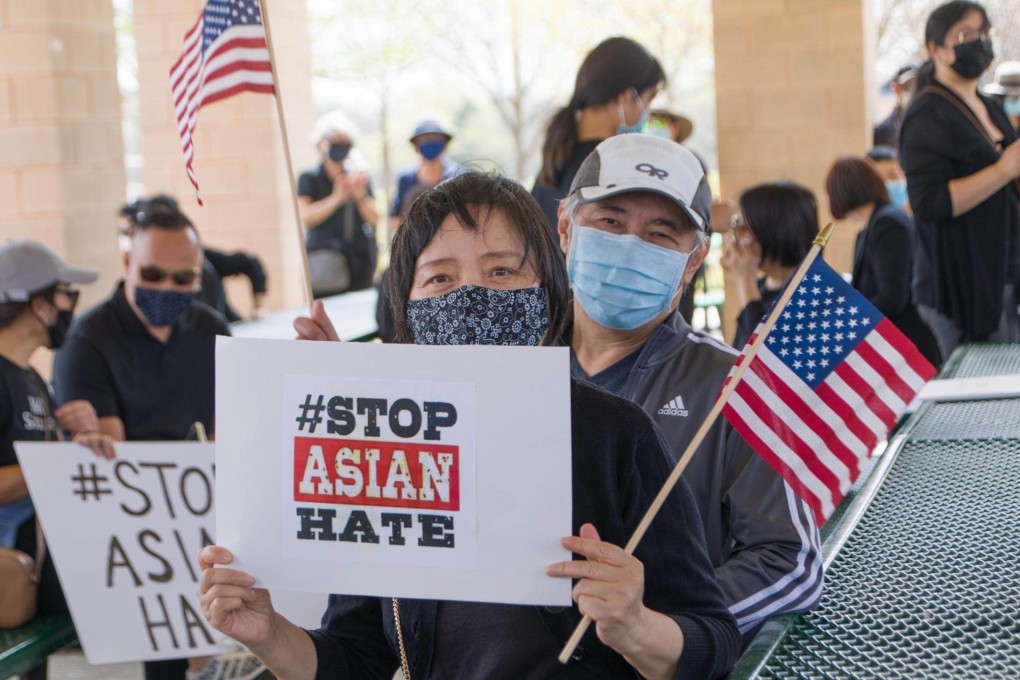 People hold signs at a Stop Asian Hate rally in Plano, Texas, on March 27. Photo: Xinhua