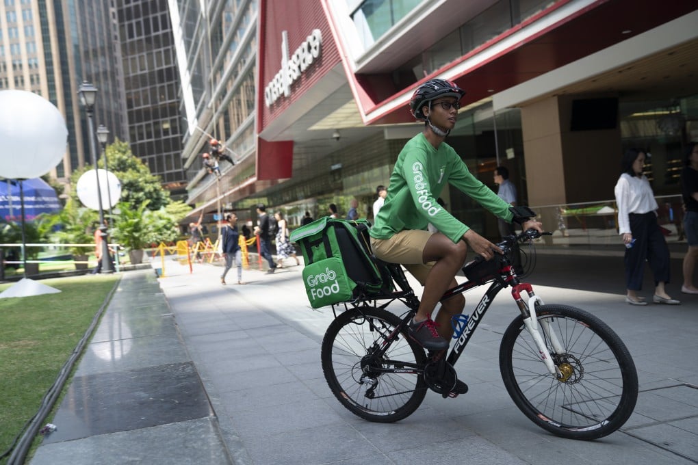 A rider for GrabFood, Grab Holdings online food-delivery platform, cycles outside Raffles Place in Singapore. The company plans to go public via a US-listed special purpose acquisiton company. Photo: Bloomberg
