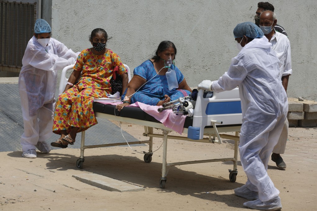 Health workers move Covid-19 patients to a new hospital to make space for new cases, as India battles a surge in coronavirus infections. Photo: AP